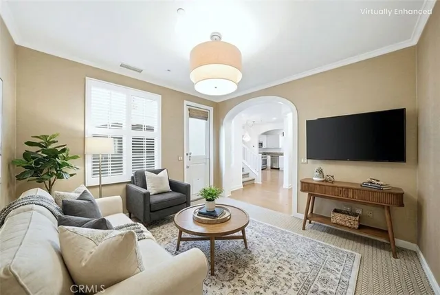 a living room with furniture a flat screen tv and a large window