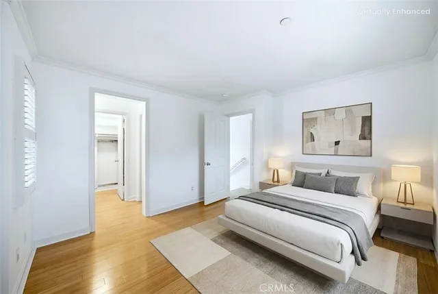 a bedroom with a bed and painting on the wall