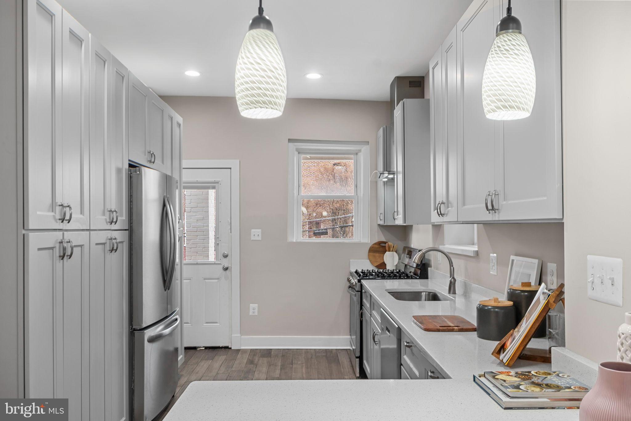 113 R Street Northeast Washington, DC 20002 - Photo 12 of 46 Modern kitchen with sleek cabinetry and light.