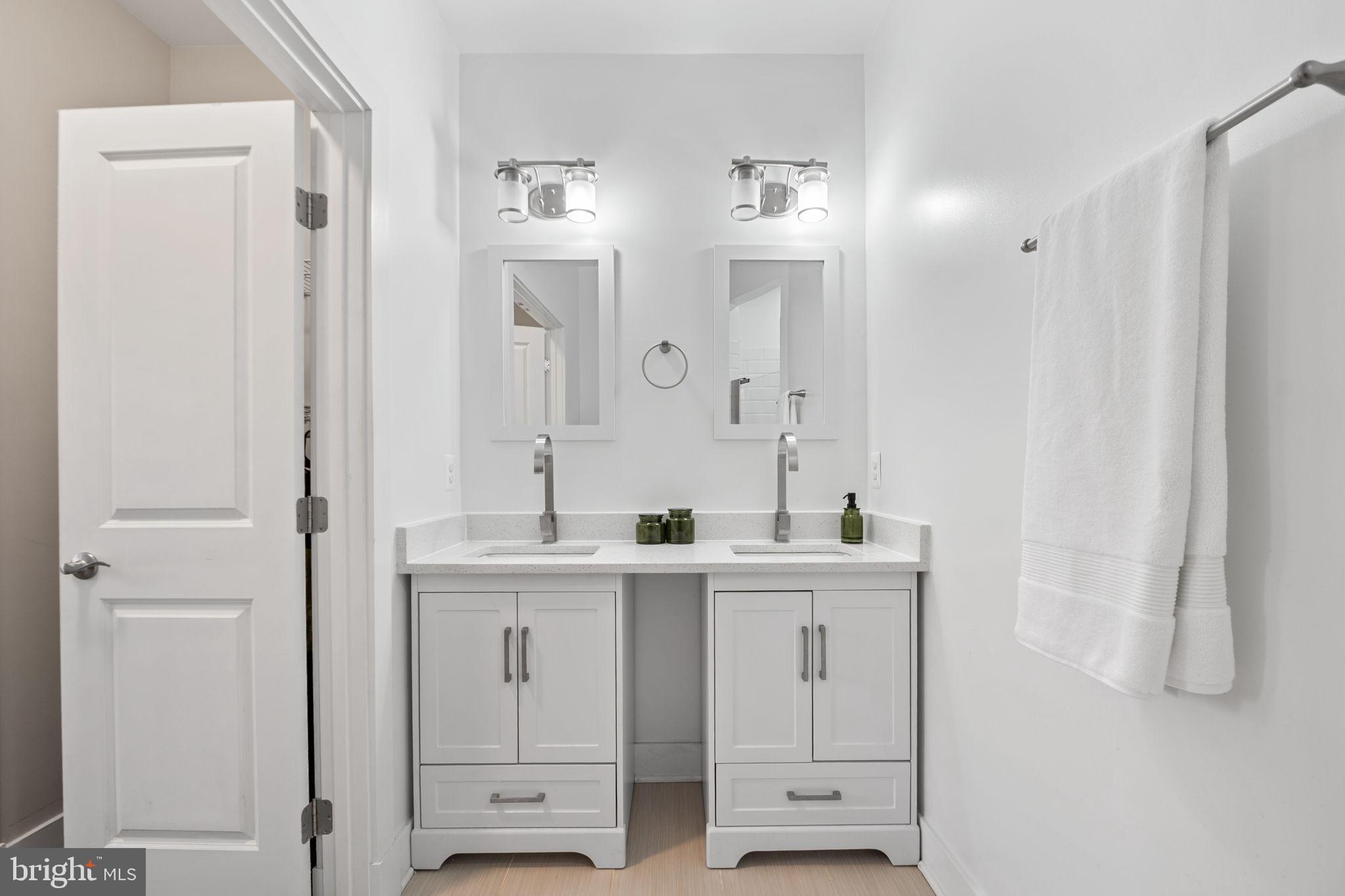 113 R Street Northeast Washington, DC 20002 - Photo 22 of 46 Sleek dual vanity in a modern bathroom.