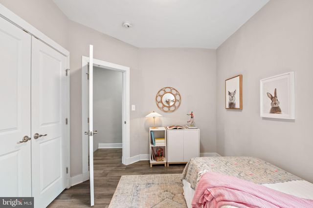 a kitchen with cabinets and wooden floor