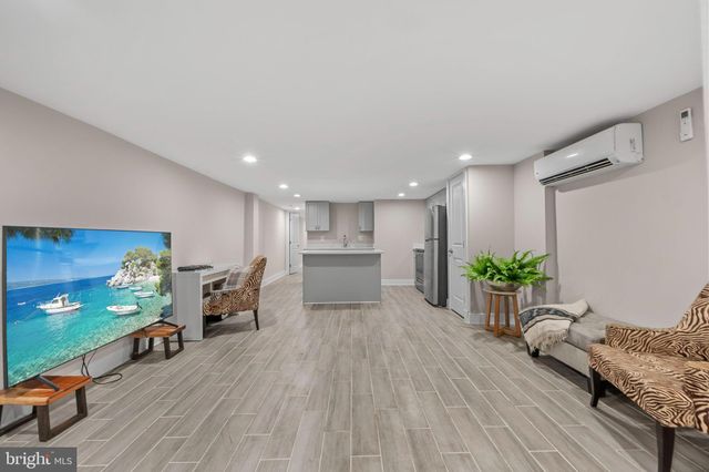 a kitchen with kitchen island a sink appliances and cabinets