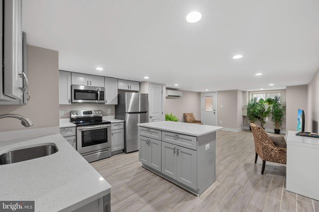 a kitchen with appliances a sink cabinets and a counter top space