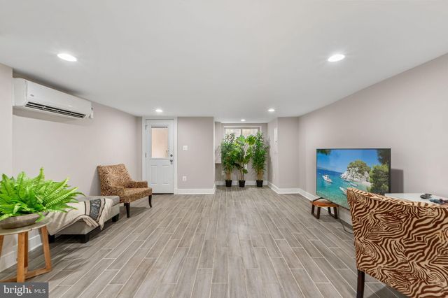 a bathroom with a sink a toilet a mirror and shower