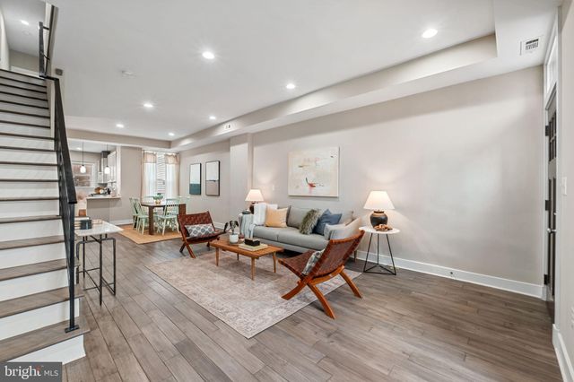 a living room with furniture a table and a potted plant