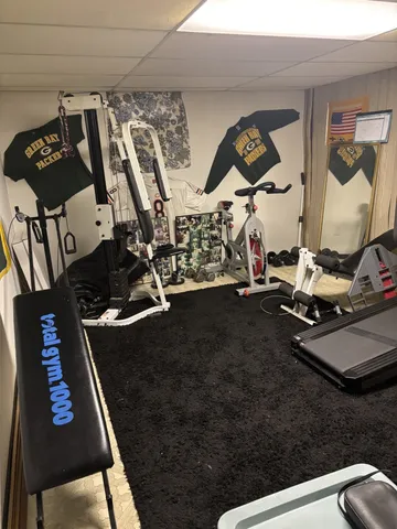 a side view of a house with a wooden bench