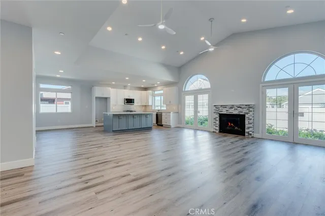a kitchen with kitchen island granite countertop a stove a sink a refrigerator and a cabinets
