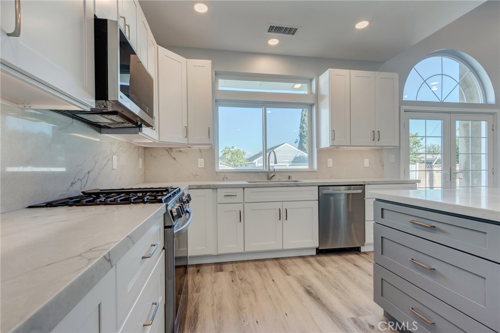 11128 Stamy Road Whittier, CA 90604 - Photo 14 of 40 a kitchen with a stove a sink and a window
