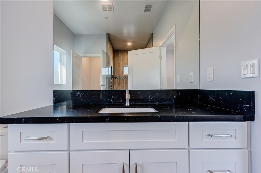 11128 Stamy Road Whittier, CA 90604 - Photo 26 of 40 a kitchen with a sink and cabinets