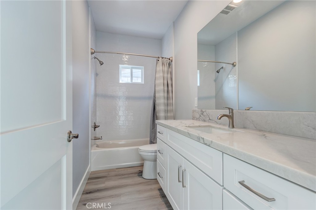 11128 Stamy Road Whittier, CA 90604 - Photo 32 of 40 a bathroom with a granite countertop sink toilet and shower