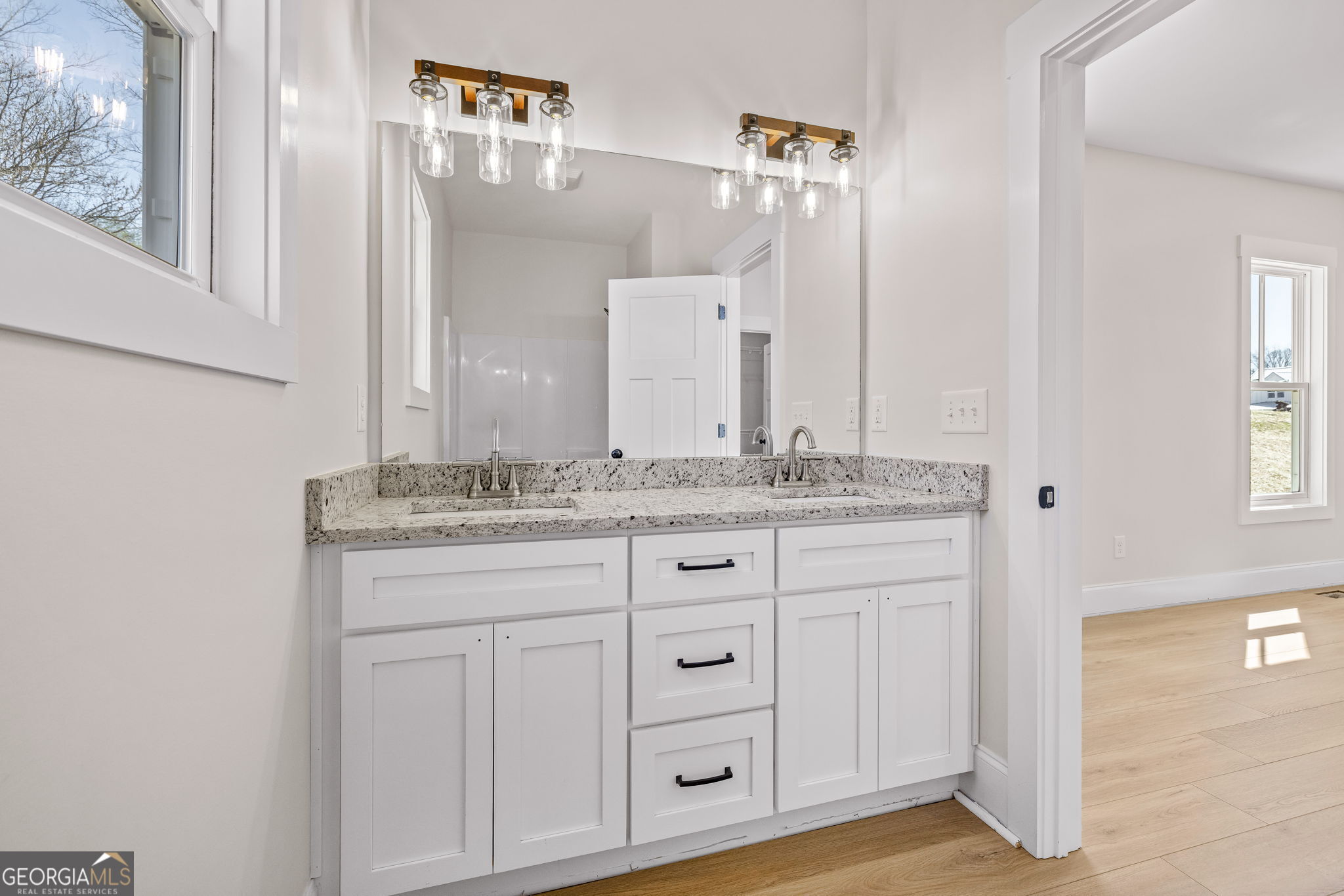 409 Roper Drive Clarkesville, GA 30523 - Photo 15 of 32 a bathroom with a granite countertop sink and a mirror