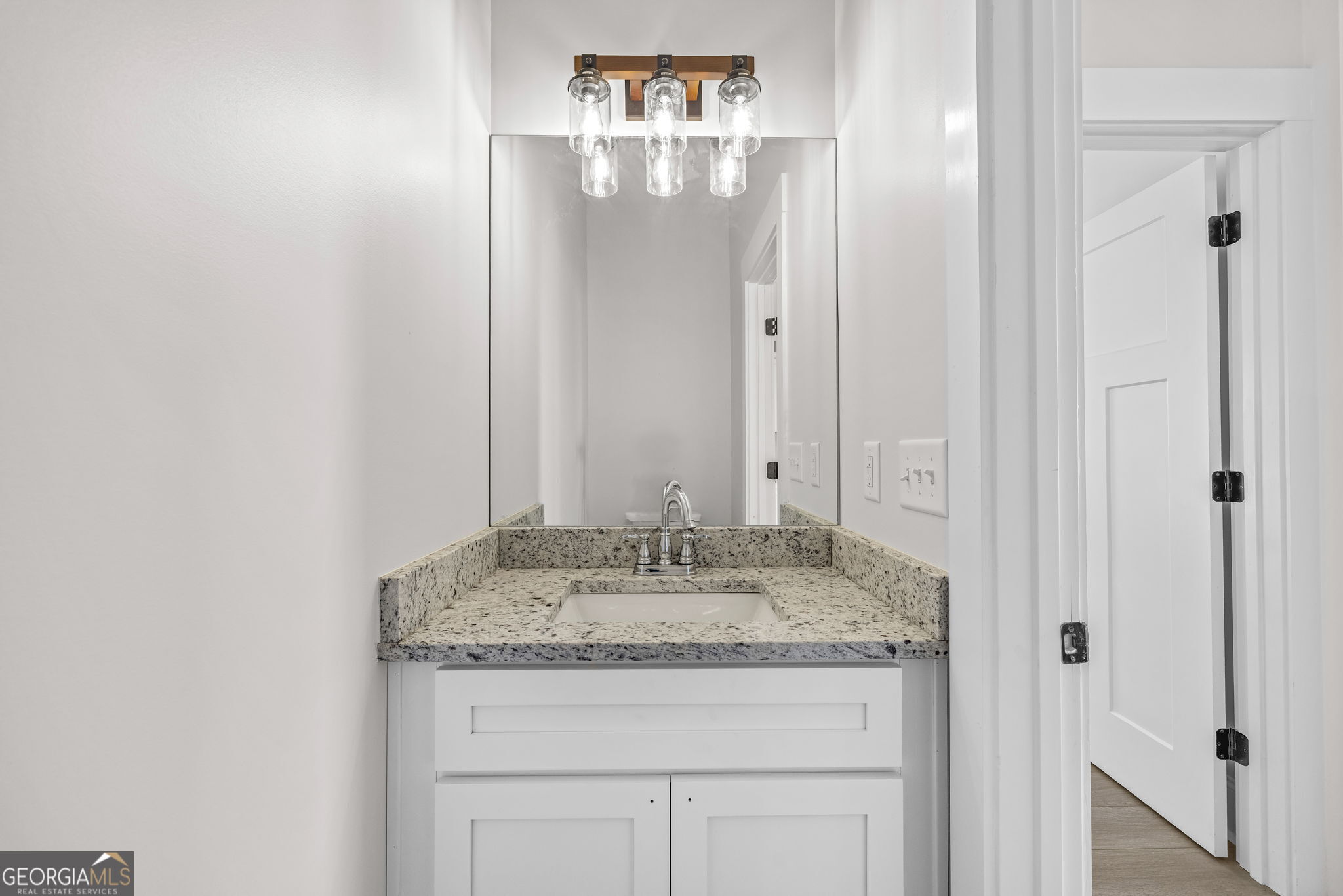 409 Roper Drive Clarkesville, GA 30523 - Photo 18 of 32 a bathroom with a granite countertop sink and a mirror