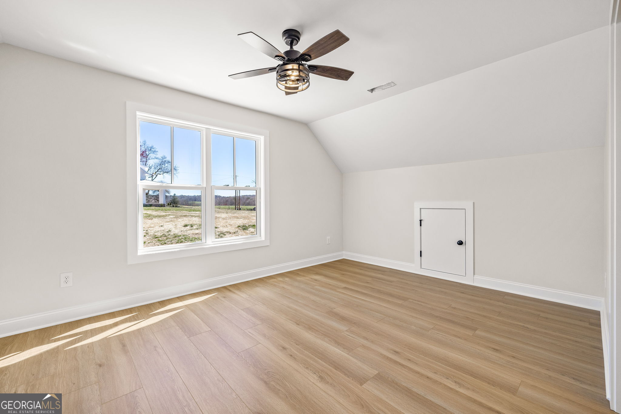 409 Roper Drive Clarkesville, GA 30523 - Photo 22 of 32 a view of an empty room with a window and a ceiling fan