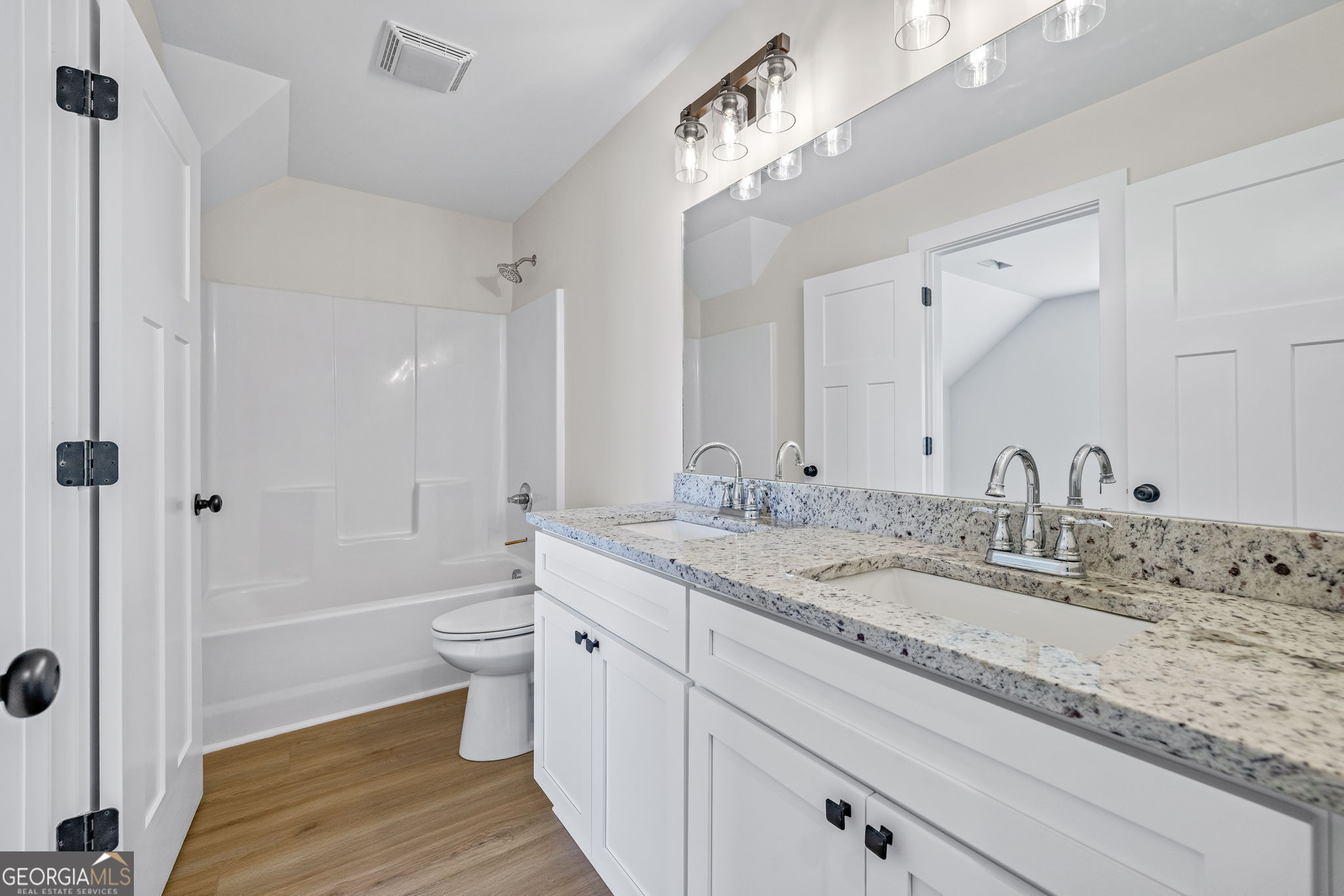 409 Roper Drive Clarkesville, GA 30523 - Photo 24 of 32 a bathroom with a granite countertop sink mirror vanity and toilet