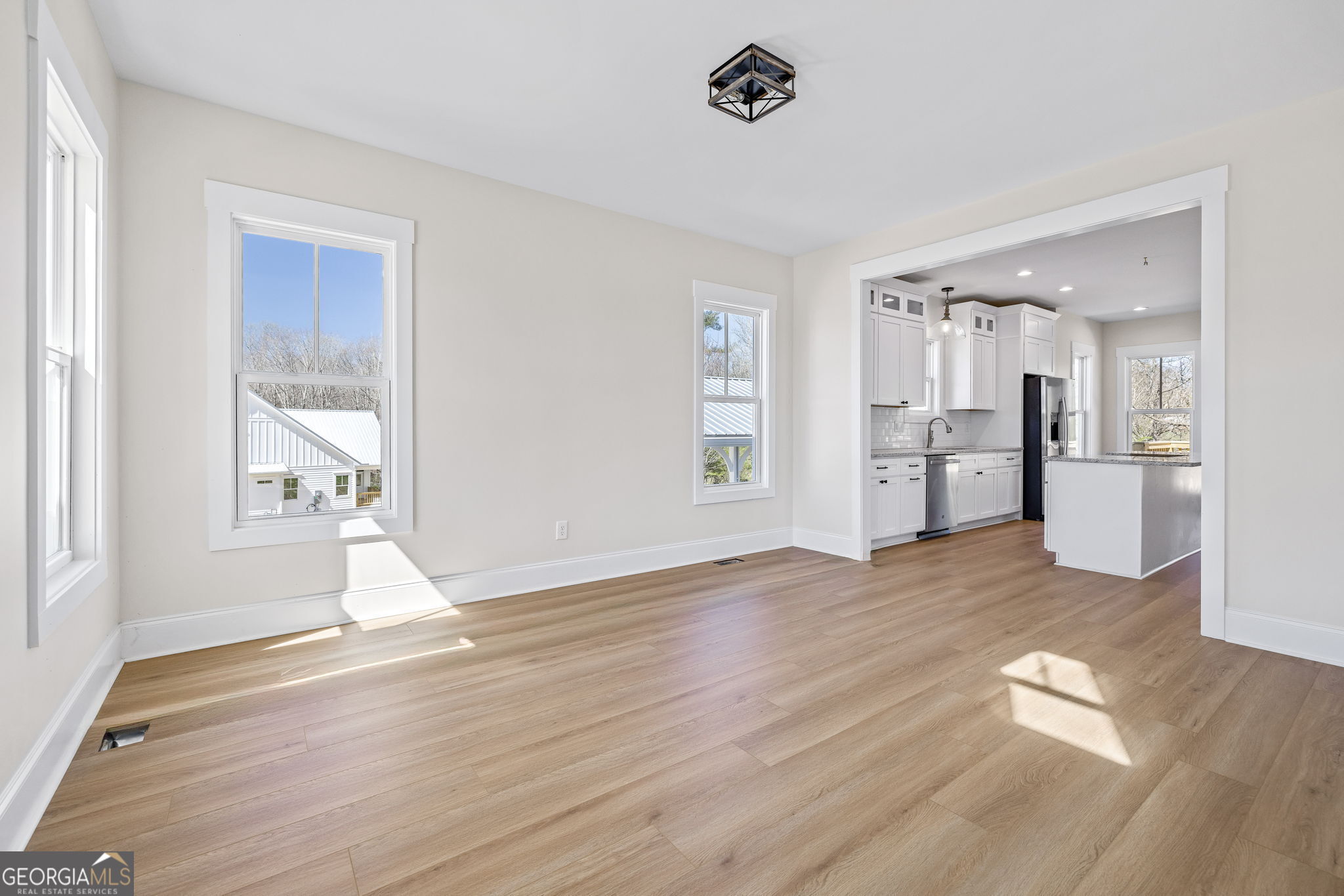 409 Roper Drive Clarkesville, GA 30523 - Photo 4 of 32 a view of empty room with wooden floor and windows