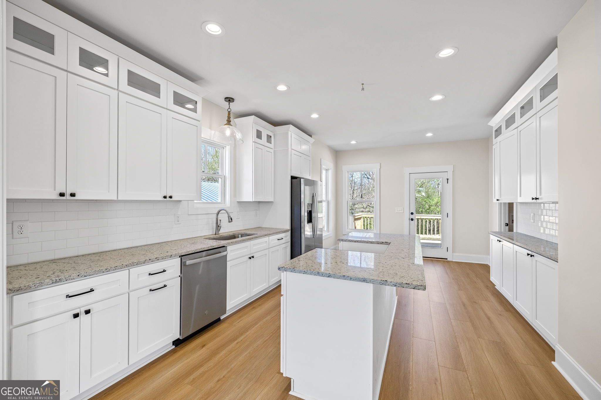 409 Roper Drive Clarkesville, GA 30523 - Photo 8 of 32 a large kitchen with stainless steel appliances lots of counter space and wooden floor