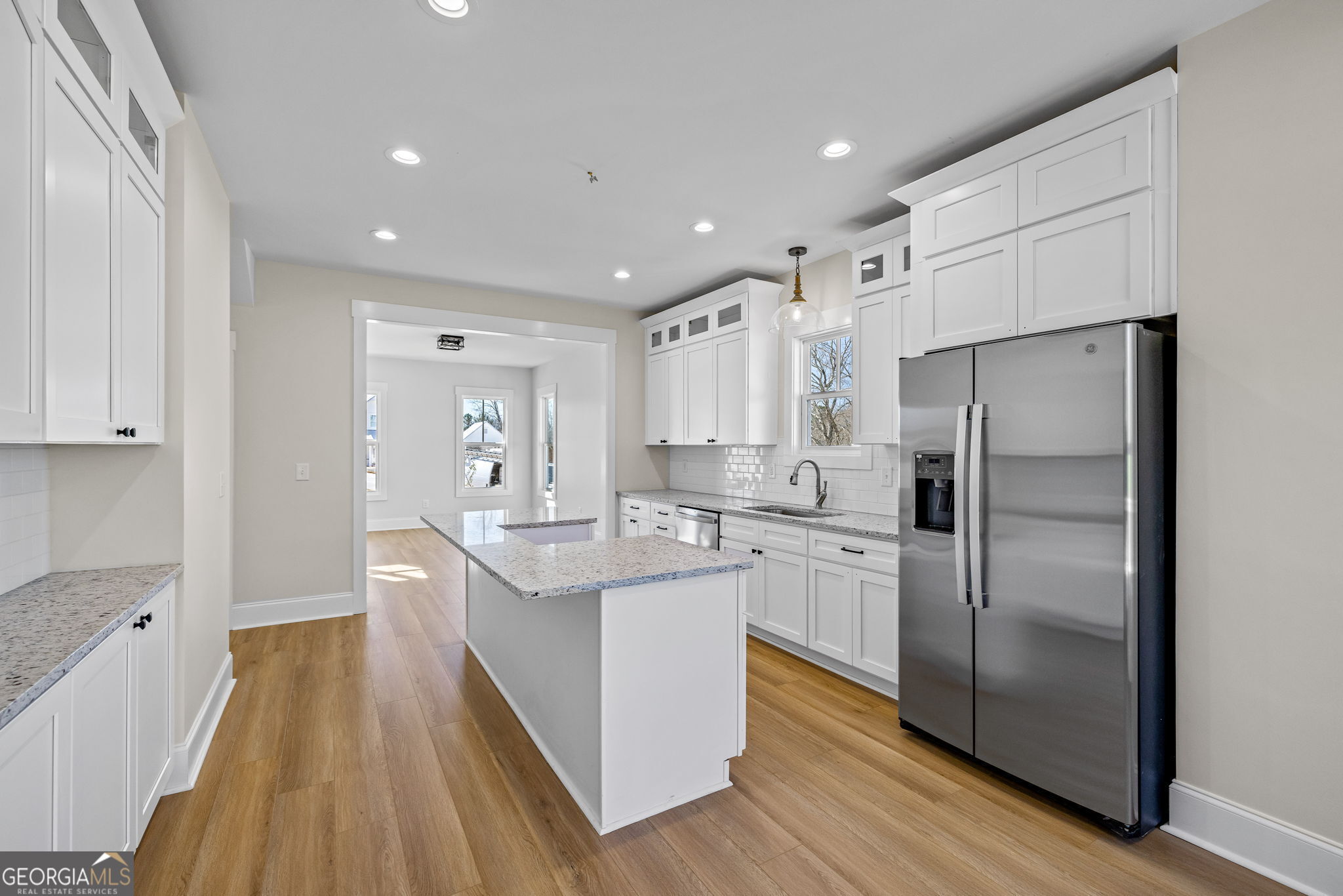 409 Roper Drive Clarkesville, GA 30523 - Photo 10 of 32 a kitchen with kitchen island white cabinets and stainless steel appliances