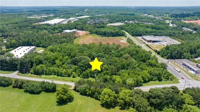 an aerial view of residential houses with outdoor space and swimming pool