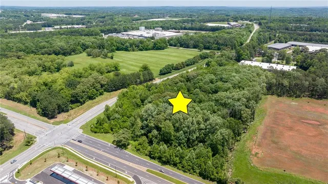 an aerial view of a house with a garden and lake view