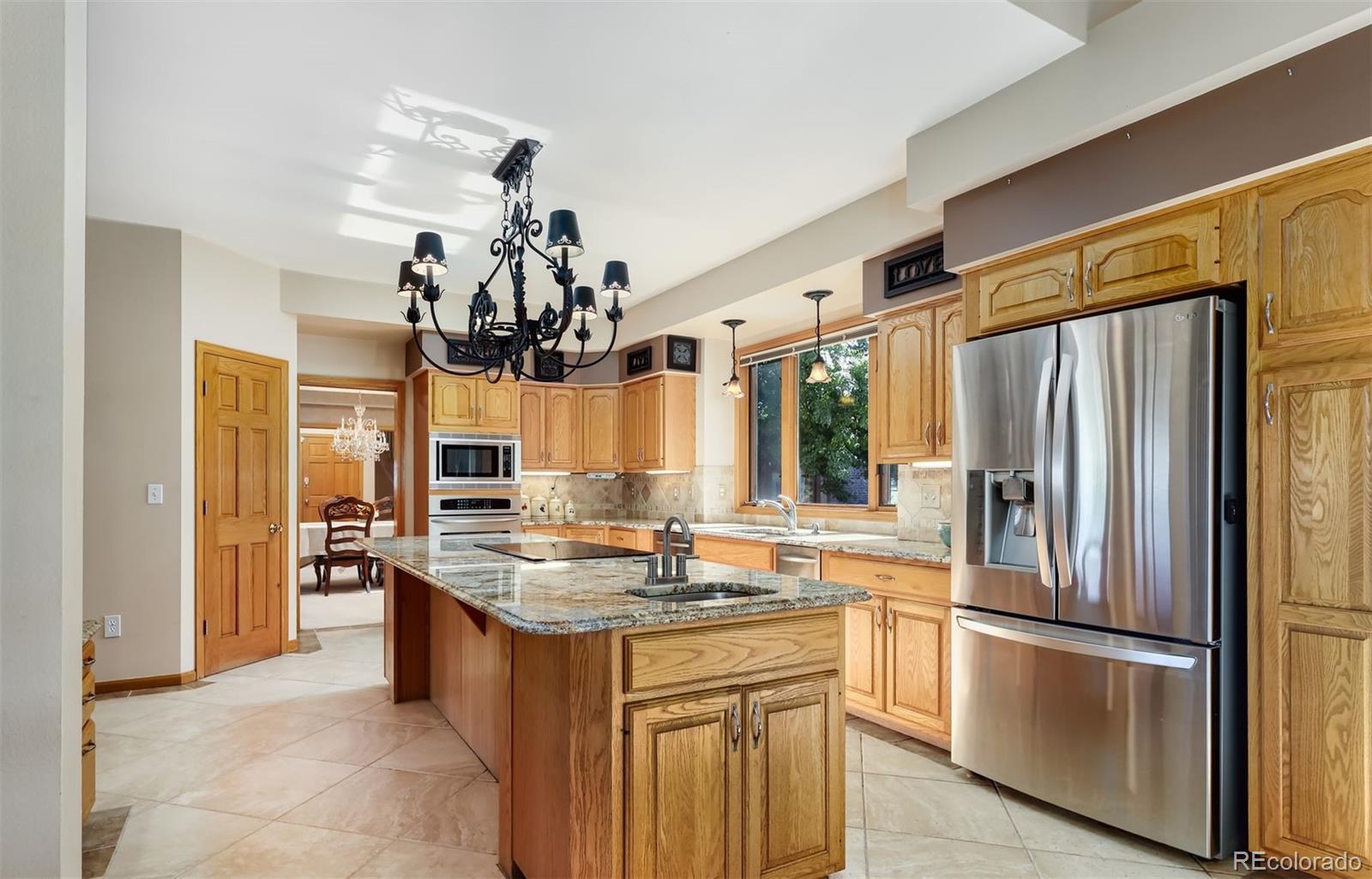 9741 Isabelle Road Lafayette, CO 80026 - Photo 11 of 39 a kitchen with stainless steel appliances granite countertop a refrigerator and a sink