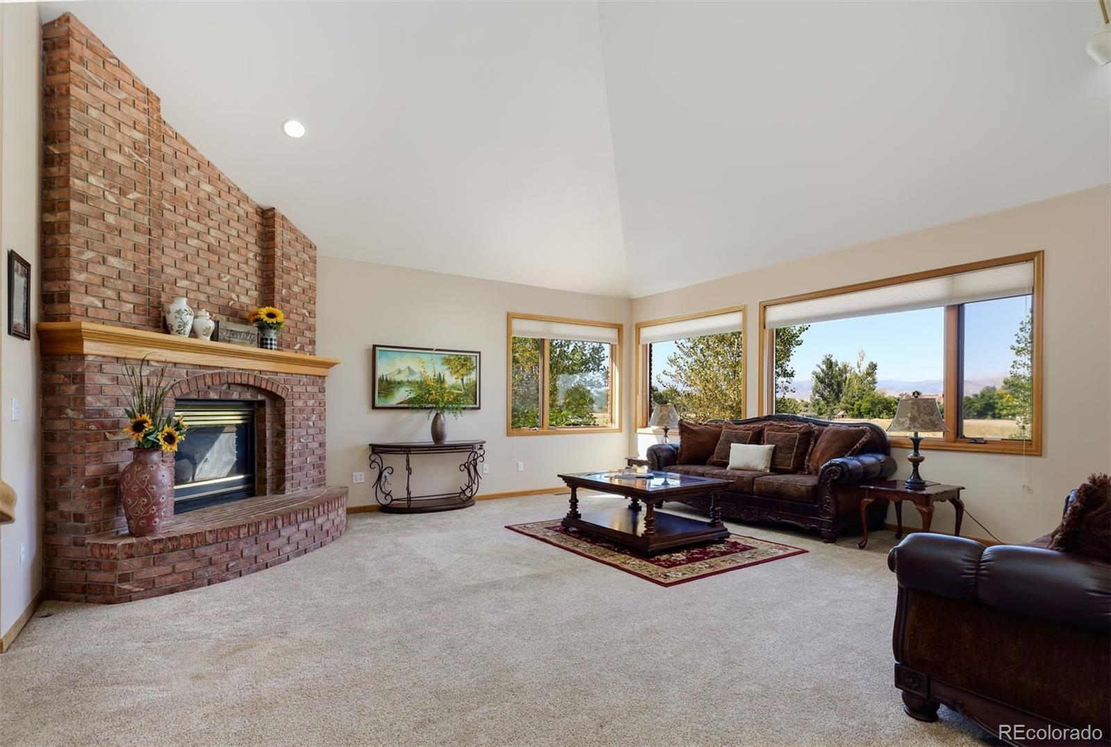 9741 Isabelle Road Lafayette, CO 80026 - Photo 14 of 39 a living room with furniture and a fireplace