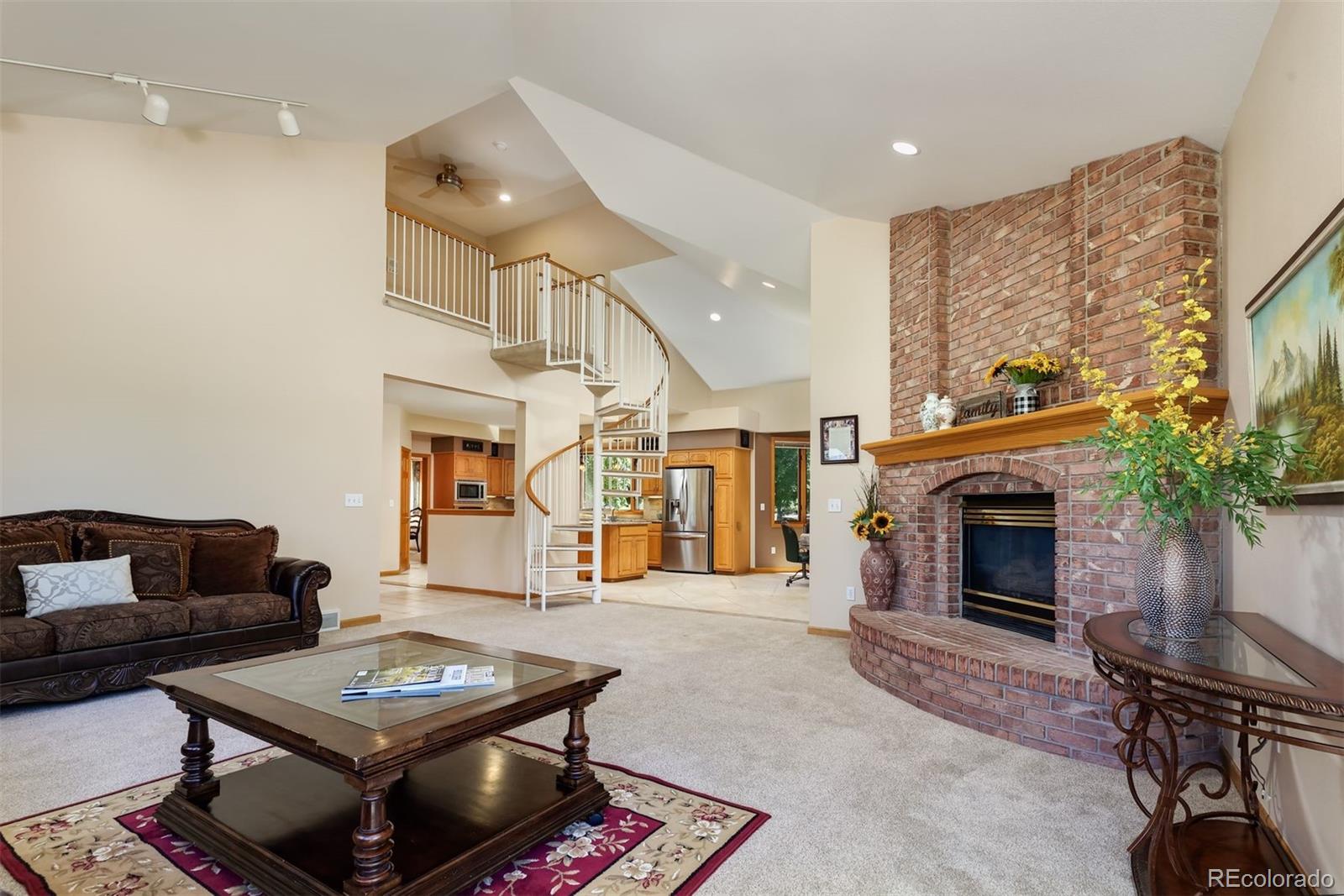 9741 Isabelle Road Lafayette, CO 80026 - Photo 16 of 39 a living room with furniture a fireplace and a flat screen tv