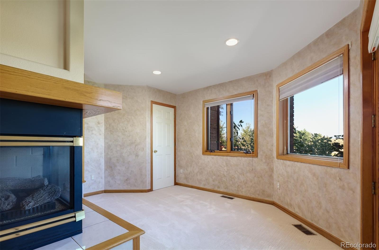 9741 Isabelle Road Lafayette, CO 80026 - Photo 23 of 39 a view of an empty room with window and wooden floor