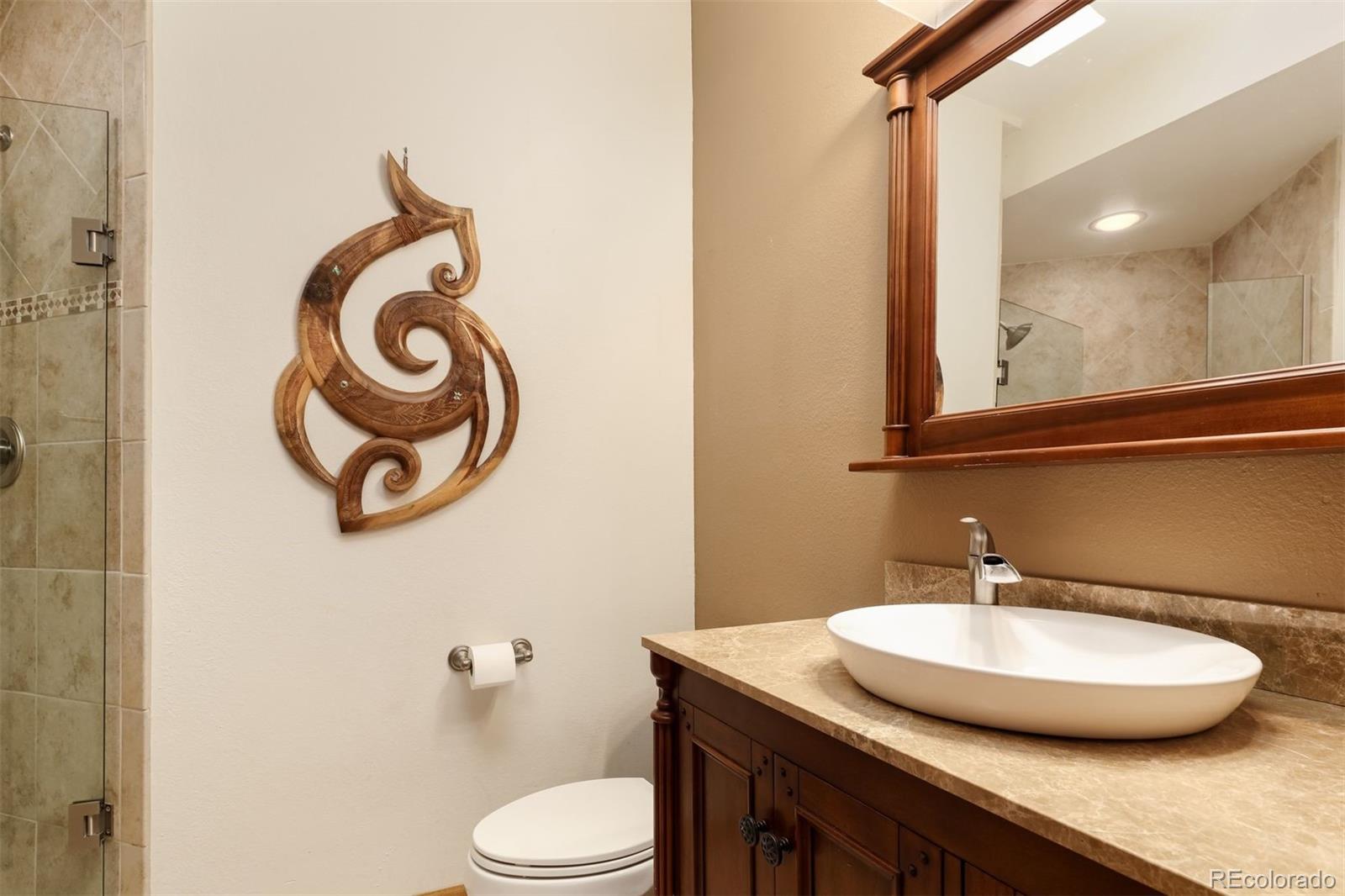 9741 Isabelle Road Lafayette, CO 80026 - Photo 26 of 39 a bathroom with a granite countertop sink and a mirror