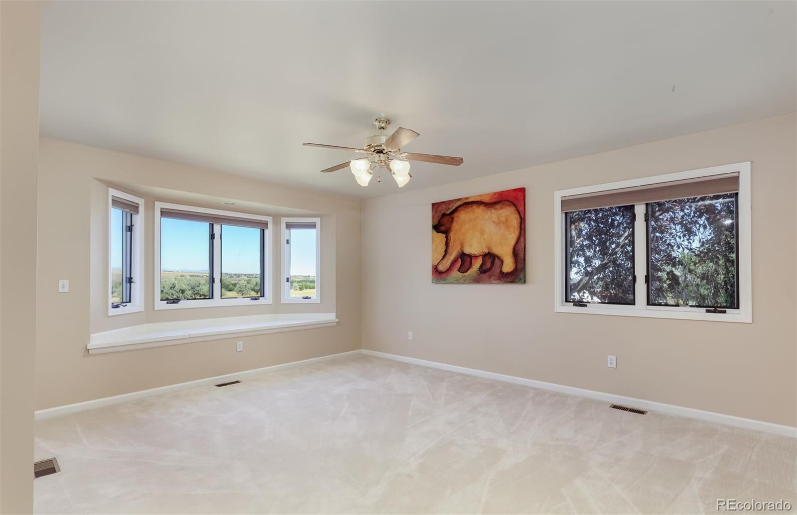 9741 Isabelle Road Lafayette, CO 80026 - Photo 27 of 39 an empty room with windows and fan