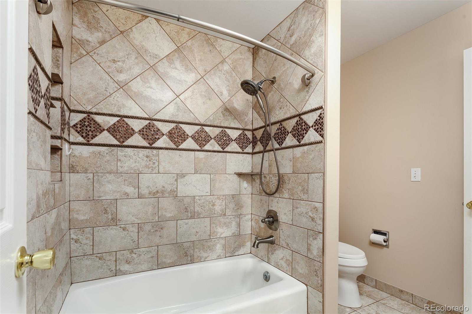 9741 Isabelle Road Lafayette, CO 80026 - Photo 31 of 39 a bathroom with a toilet and a shower