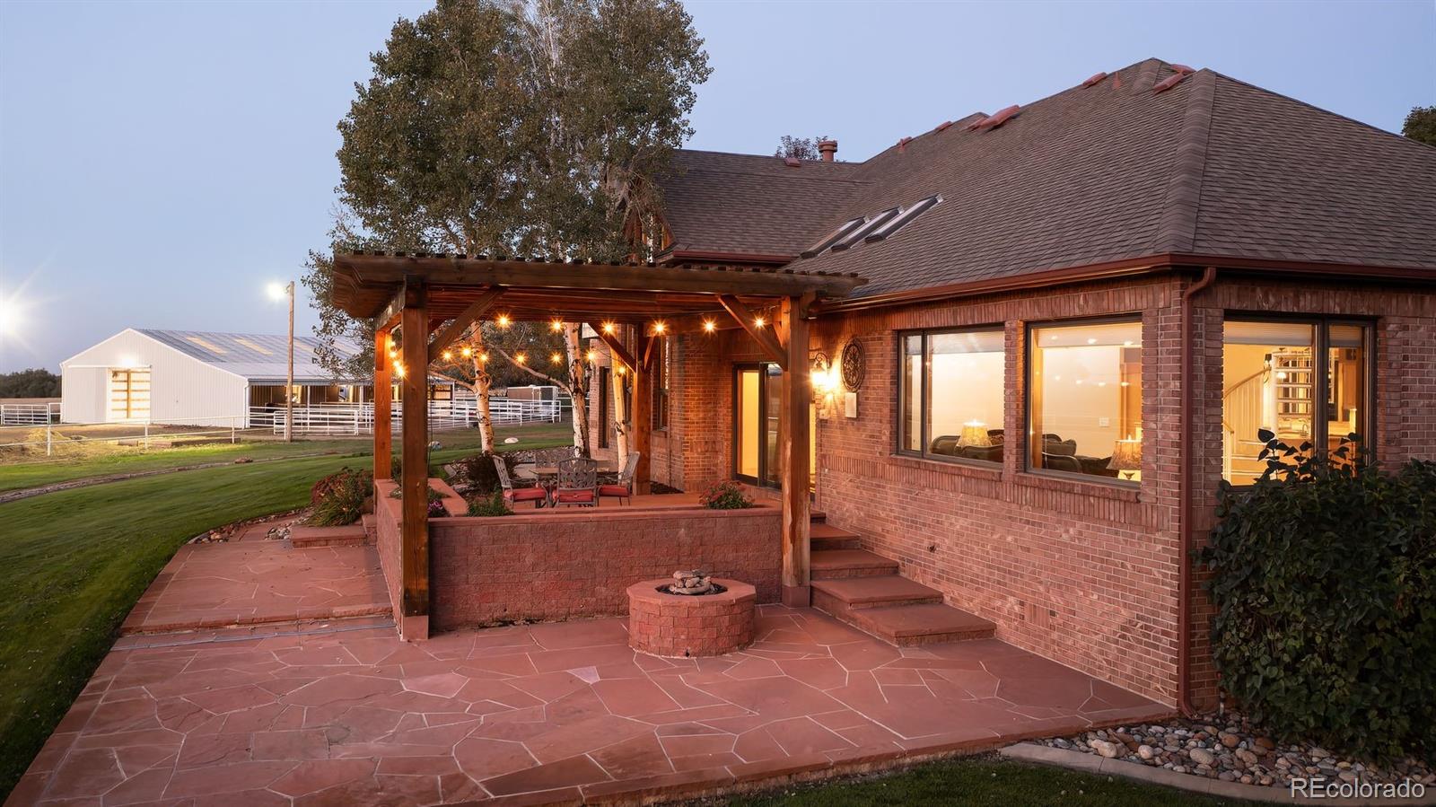 9741 Isabelle Road Lafayette, CO 80026 - Photo 34 of 39 a view of a patio with table and chairs potted plants and floor to ceiling window