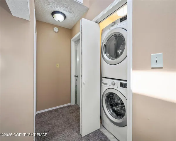 a view of a house with backyard and a tree