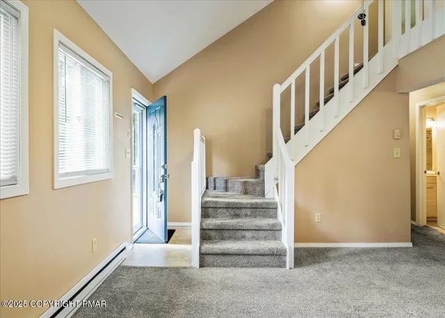 a view of a kitchen with a sink and a refrigerator
