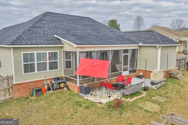 a backyard of a house with table and chairs