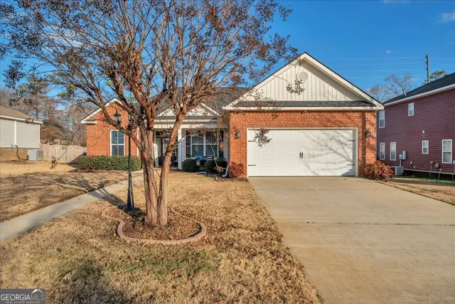 a front view of a house with a yard covered in snow