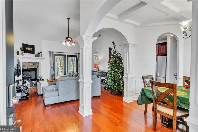 a living room with furniture fireplace and potted plants