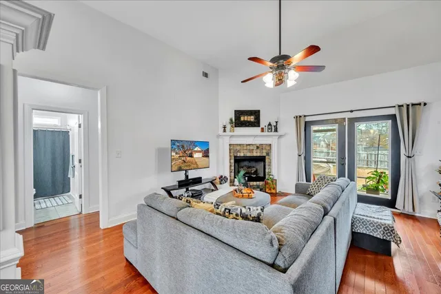 a living room with furniture a fireplace and a chandelier