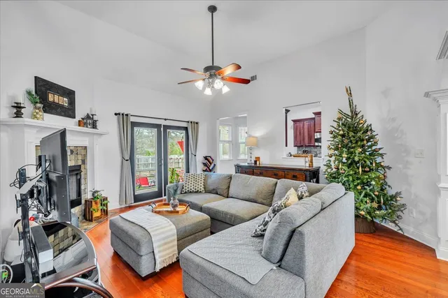 a living room with patio furniture and a chandelier