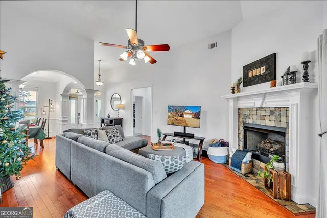 a living room with furniture a fireplace and a flat screen tv