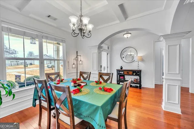 a view of a dining room with furniture window and wooden floor