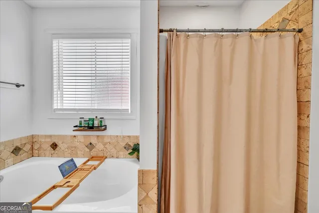 a bath tub sitting in a bathroom next to a window