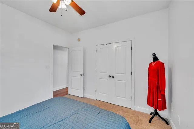 a bathroom with a granite countertop sink toilet a mirror a vanity and shower