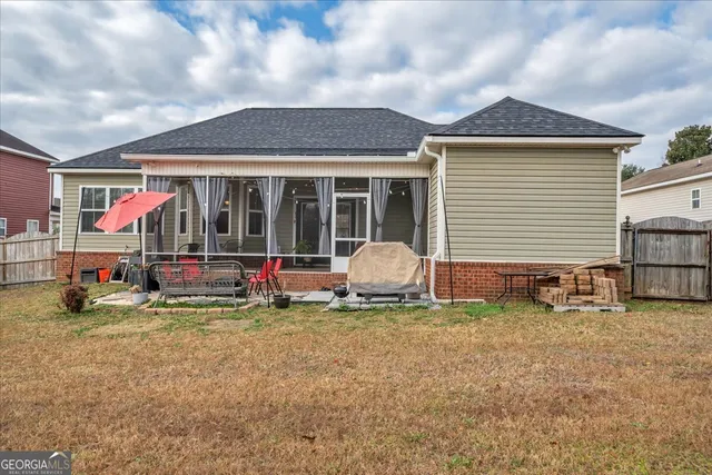 an outdoor sitting area with furniture and umbrella
