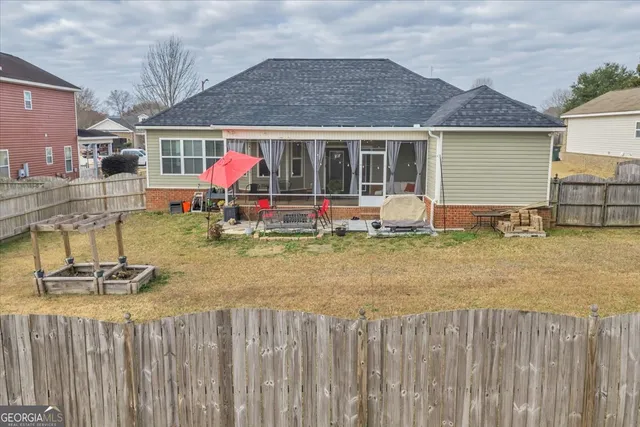 a front view of house with wooden fence