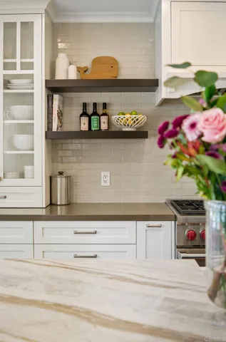 a kitchen with a potted plant on the counter and cabinets