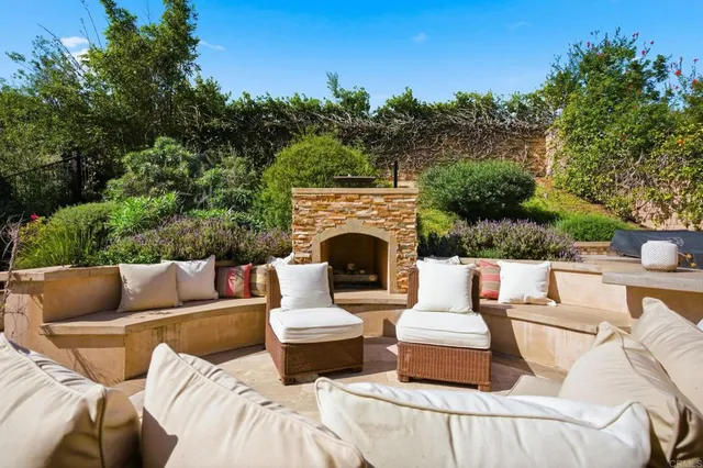 a view of a patio with couches and a fire pit