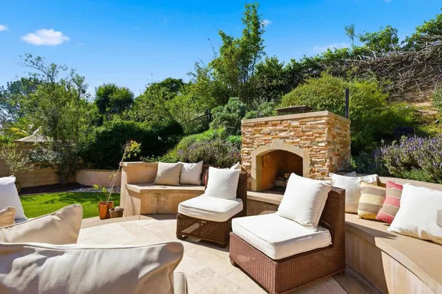 a view of a patio with couches chairs and a fire pit