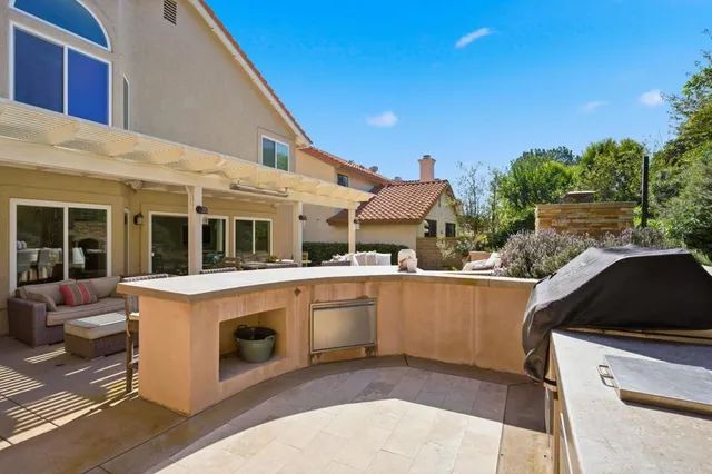 a view of a white house next to a yard