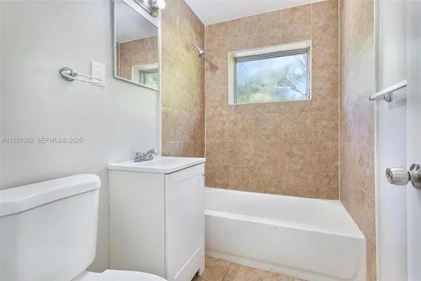 a bathroom with a sink a toilet and bathtub