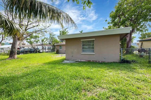 a view of a backyard with a tree